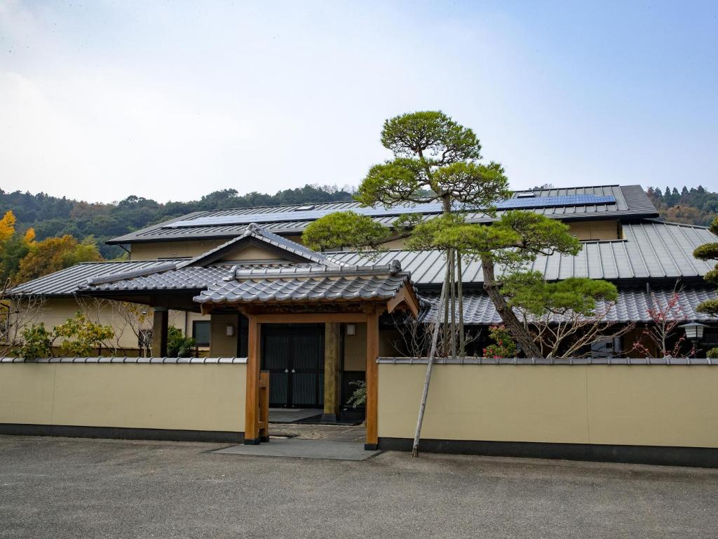 a house with solar panels on the roof at Mikuniya in Kunisaki