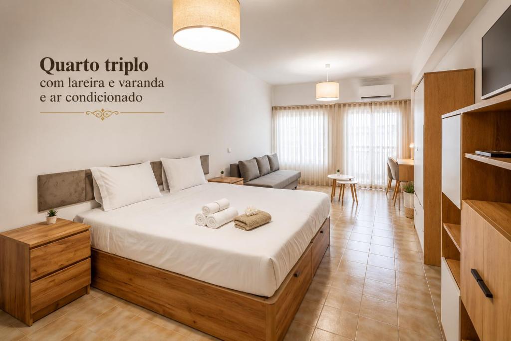 a bedroom with a bed with two towels on it at Rooms4you 2 in historic center of Braga in Braga