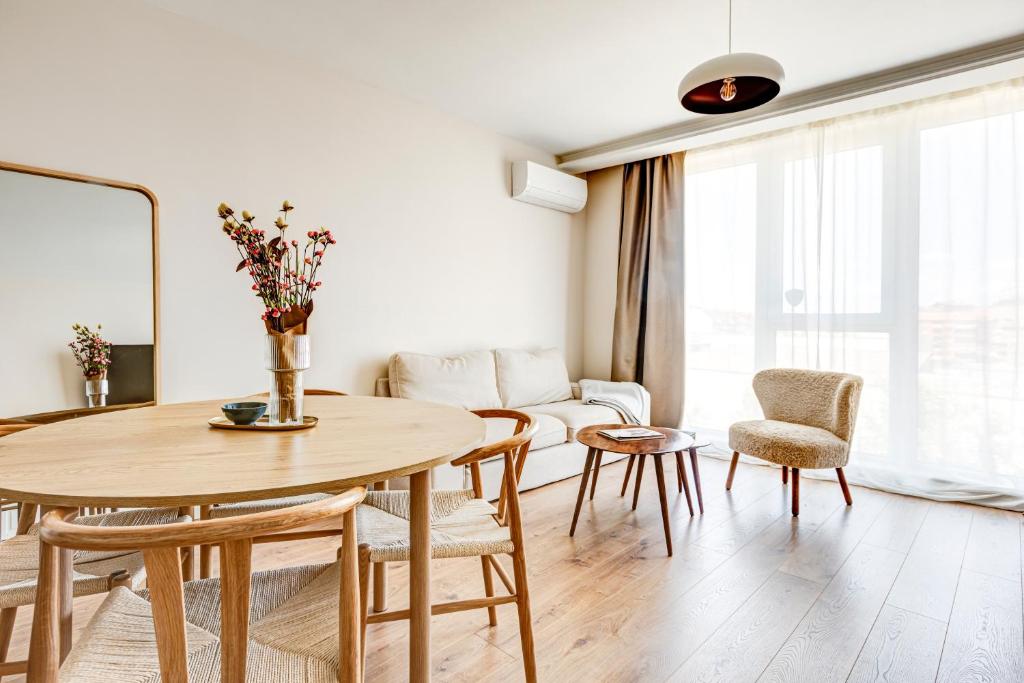 a living room with a table and chairs and a couch at Dalia Residence - Boutique Apartment in Sofia