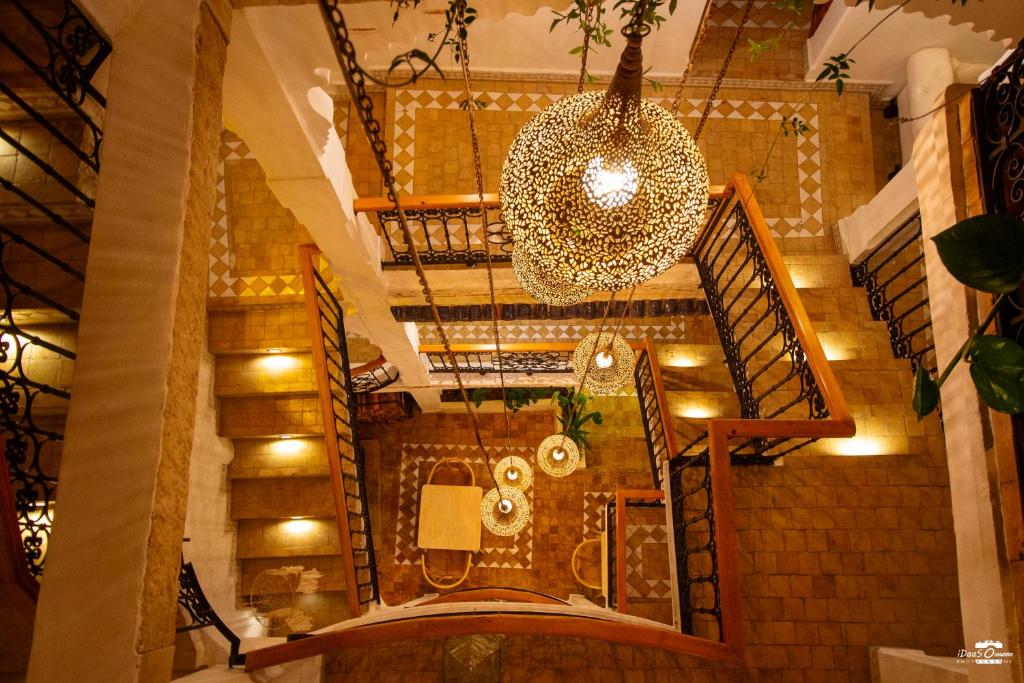 an overhead view of a staircase with a chandelier at Riad Nila in Chefchaouen