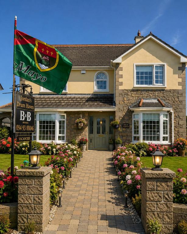 a house with a flag in front of it at Jordan's Drum Haven B&B, Knock in Knock