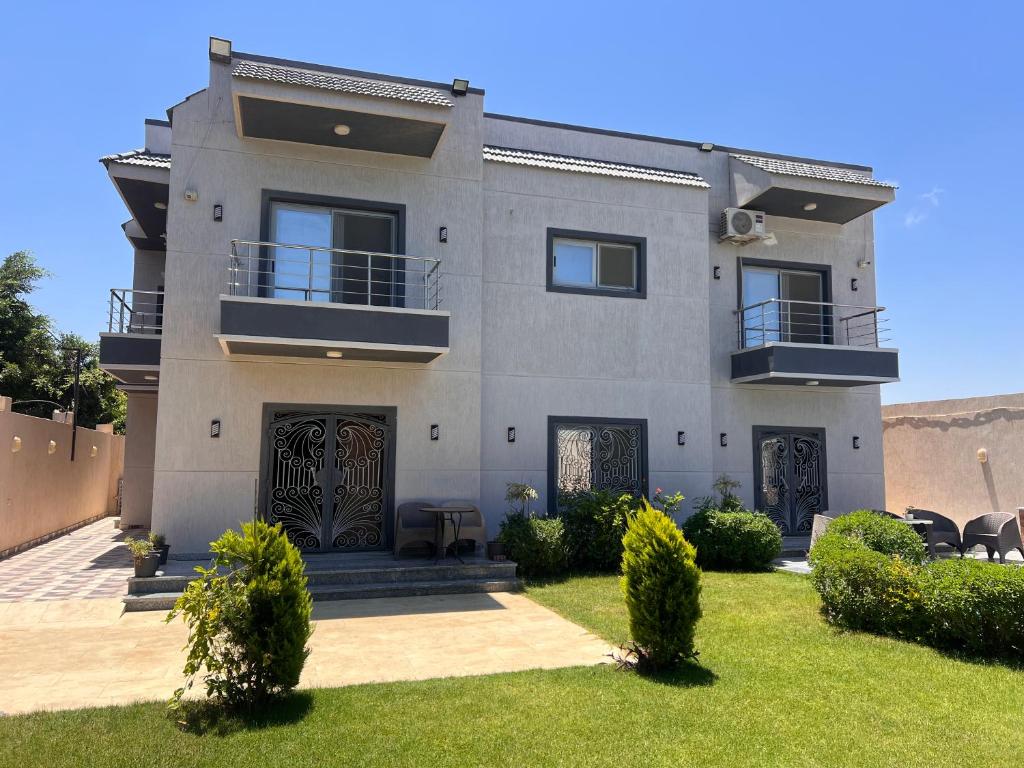a house with a lawn in front of it at King mariout villa LA FIESTA in Borg El Arab