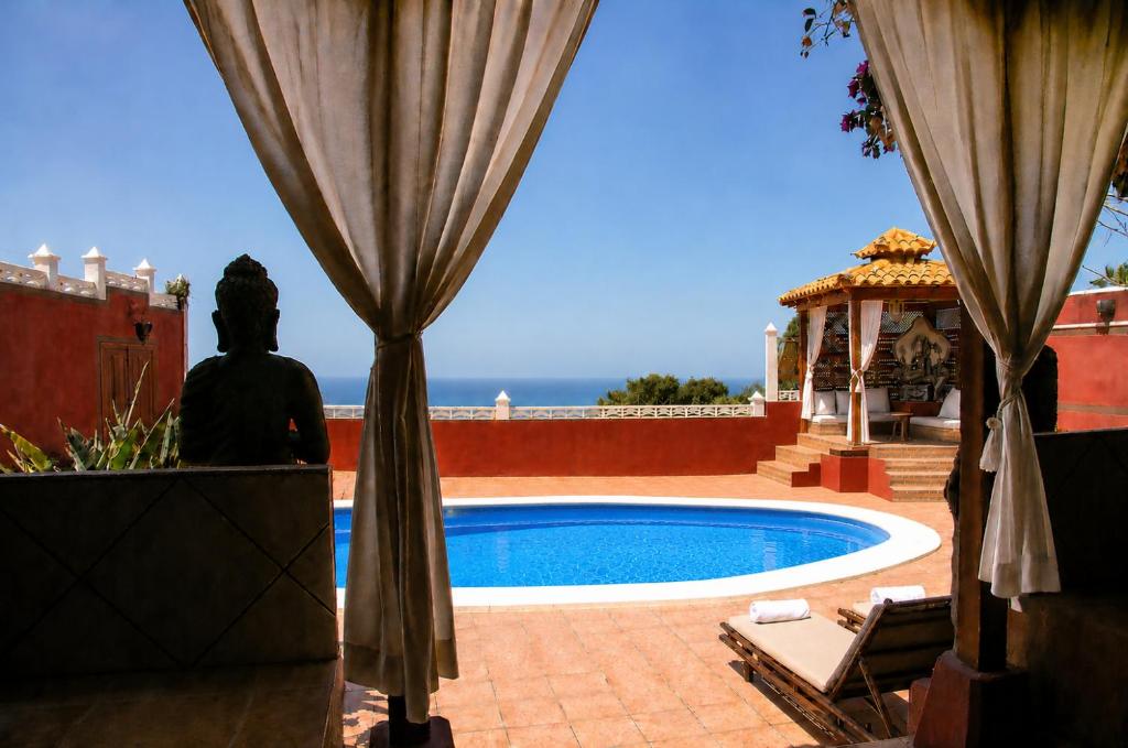 a view of a swimming pool from the patio of a house at Villa Zen - Tu oasis en el sur de Tenerife in Adeje