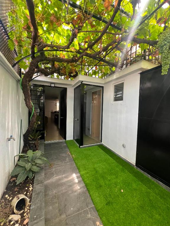 a house with a green lawn in the yard at Serena Boutique Duplex in Madrid