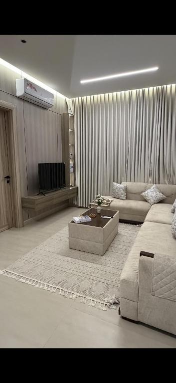 a living room with a couch and a coffee table at Elite Stay in Buraydah