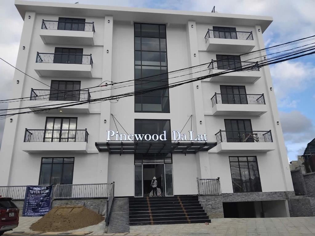 a woman standing in the doorway of a white building at Pinewood Dalat in Da Thien