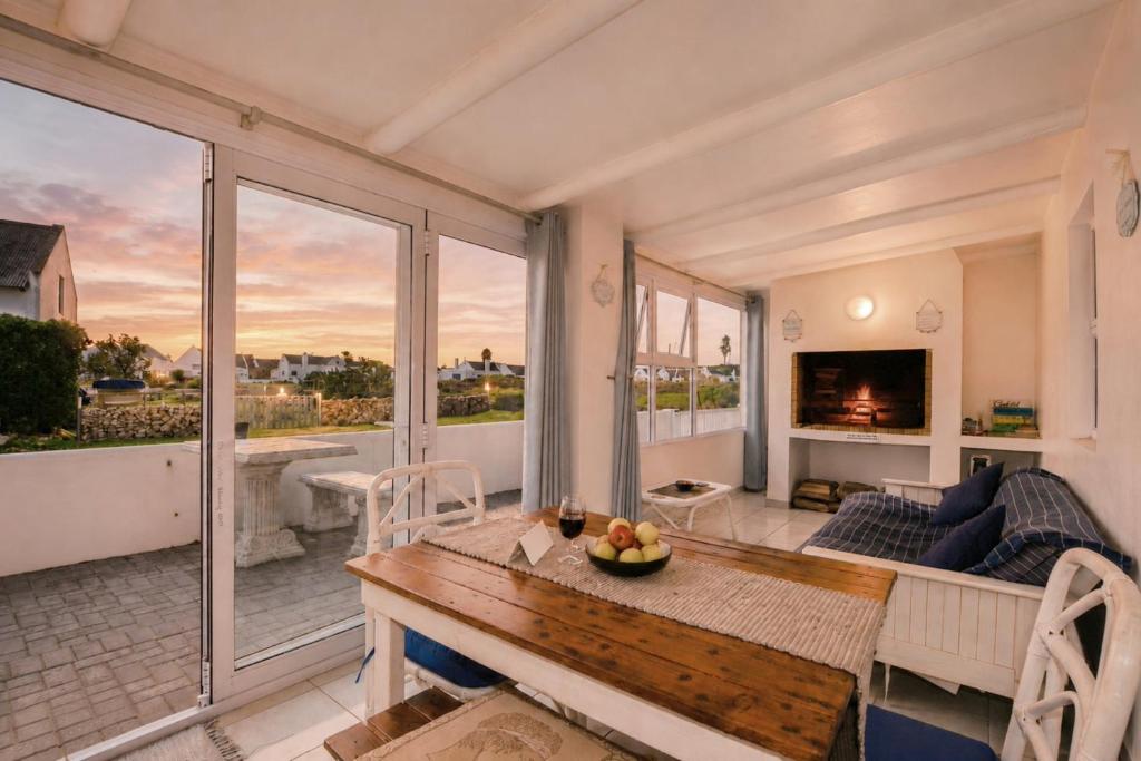 a living room with a table and a couch at Jacobsdaller #1 in Jacobs Bay
