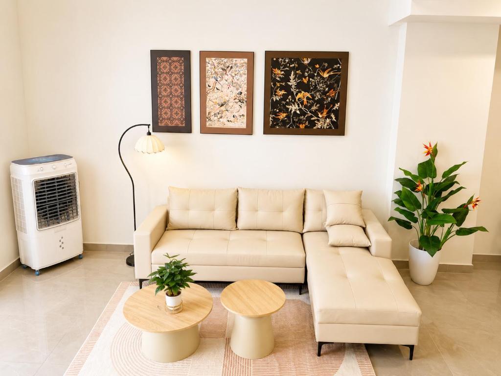 a living room with a couch and a table at VSIP Executive Living in Hòa Lợi (1)