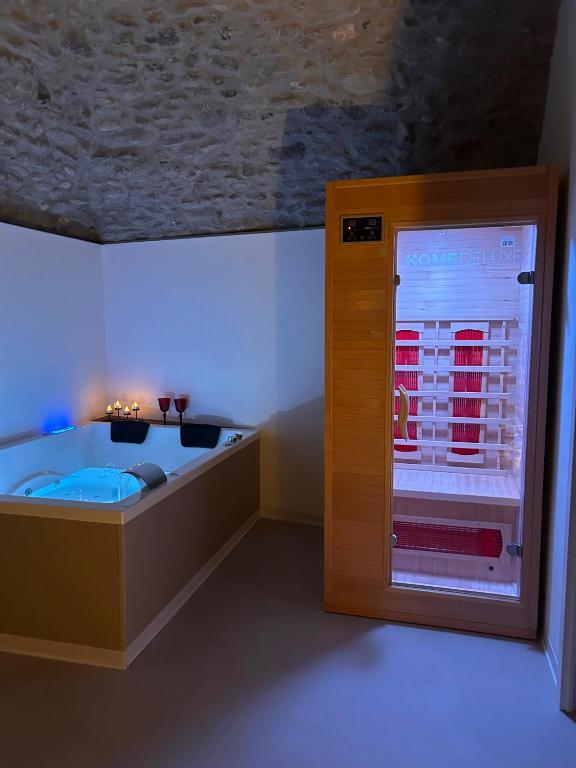 a room with a bed and a large window at AmarVite con spa privata in Dolceacqua
