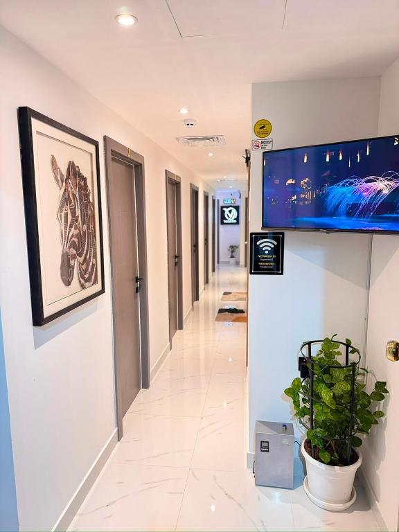 a hallway in a hospital with a picture of a horse on the wall at Vogue Inn in Abu Dhabi