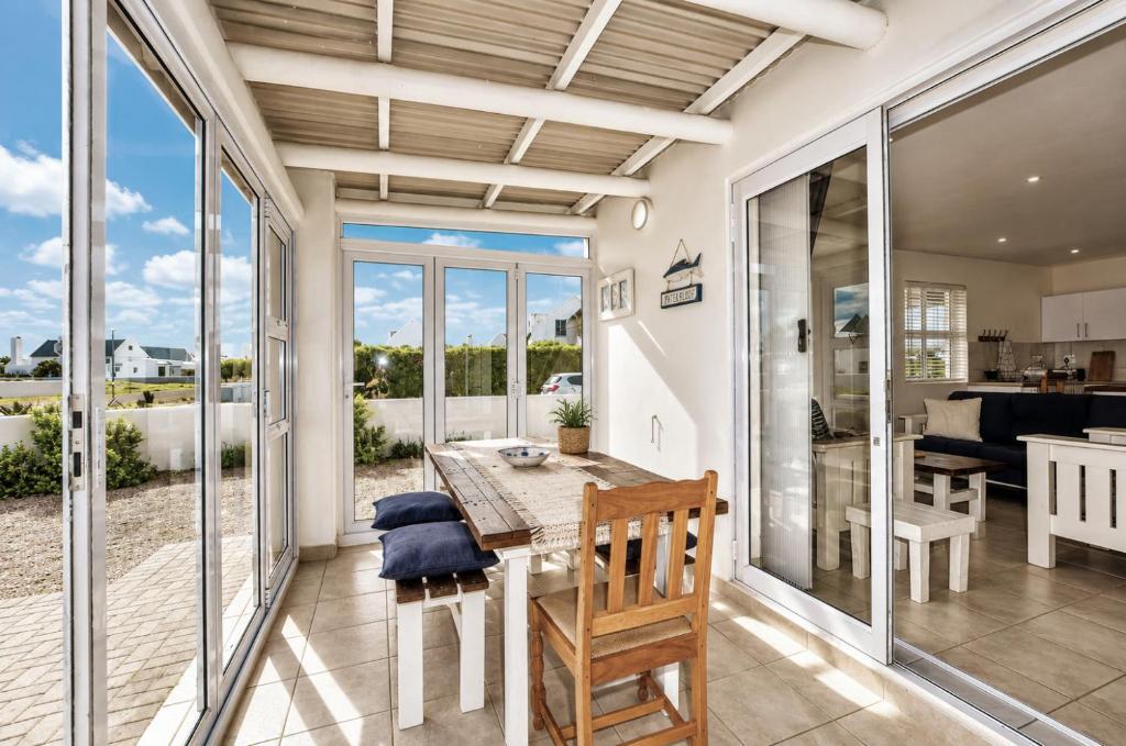a kitchen and dining room with a table and chairs at Jacobsdaller #2 in Jacobs Bay