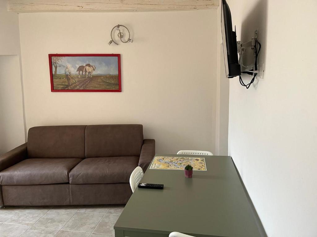 a living room with a couch and a table at La Bella e La Bestia in Lierna