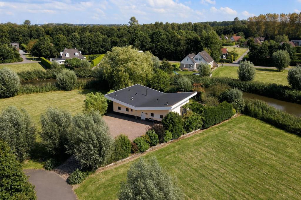 an aerial view of a house with a driveway at Villa Vera - Comfort, Space, Sauna & Hot Tub in Private Garden in Zeewolde