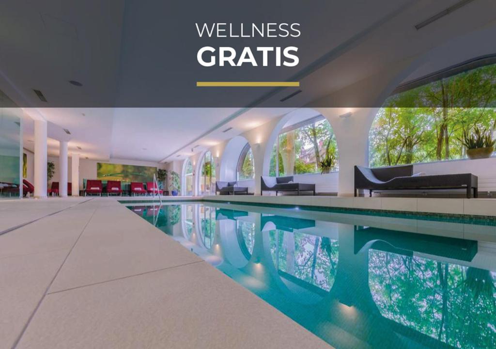 a swimming pool in a building with the words wellness crafts at Pytloun Schlosshotel Weikersdorf in Baden
