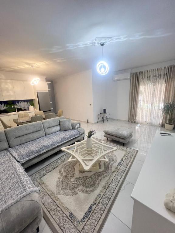 a living room with a couch and a table at Twobedrooms house in Polisi i Vogël
