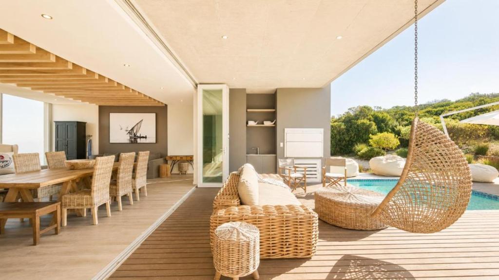 an open living room with a dining table and chairs at Horizon House in Mossel Bay