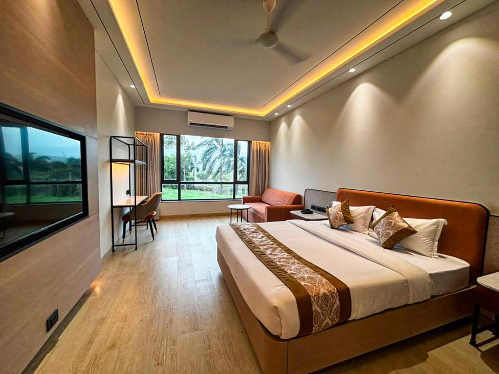 a bedroom with a large bed in a room at Hotel Grand Parivaar in Igatpuri