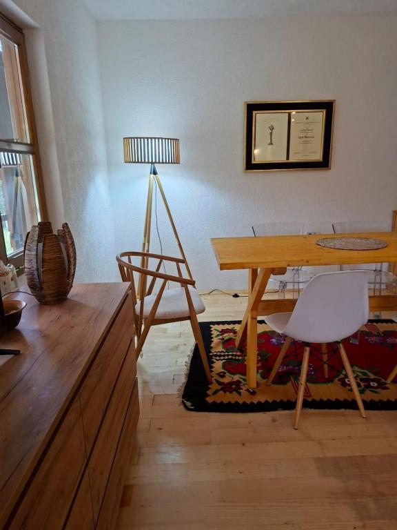a room with a table and a chair and a lamp at Vig in Njegovuđa