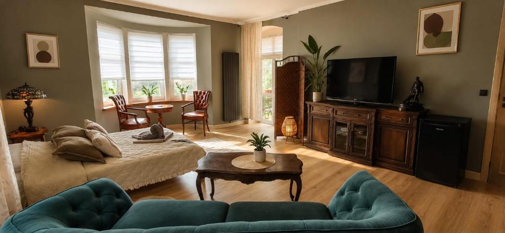 a living room with a couch and a tv at Apartamenty Sunny Bear in Jelenia Góra