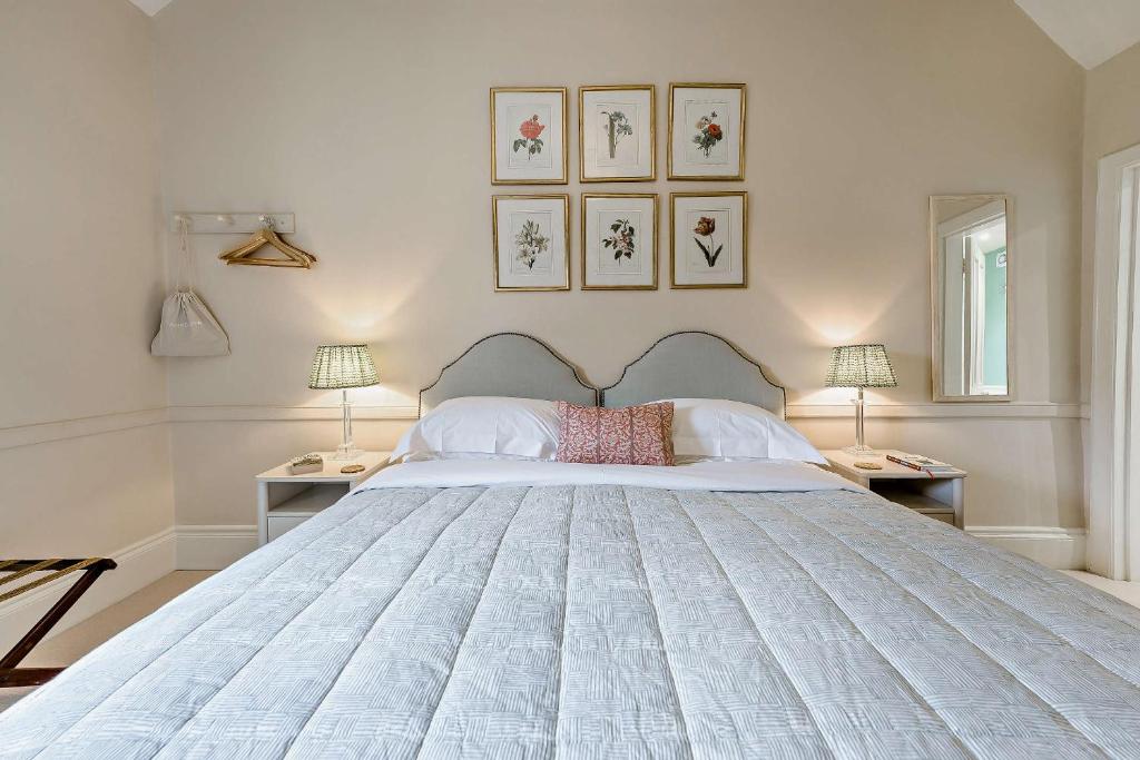 a bedroom with a large white bed with two lamps at Tiger Inn - Grace in Eastbourne