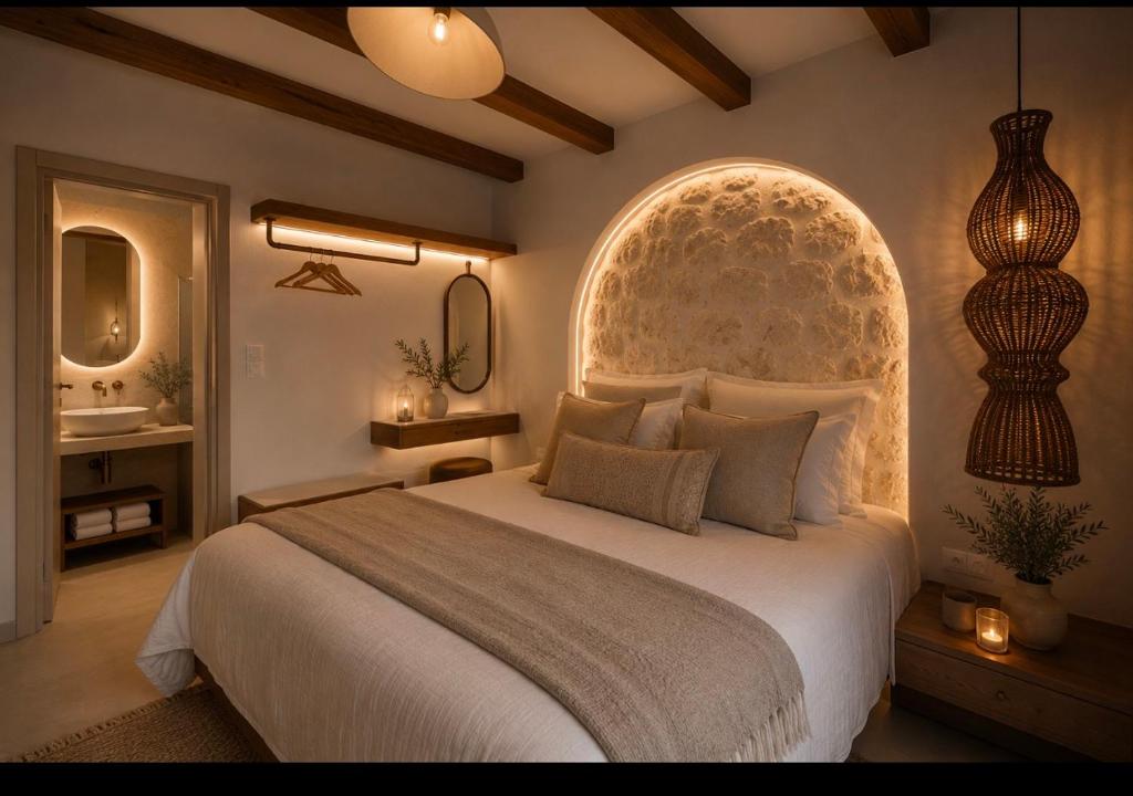 ein Schlafzimmer mit einem großen Bett und einem Waschbecken in der Unterkunft ARGO Luxury Suites in Milína