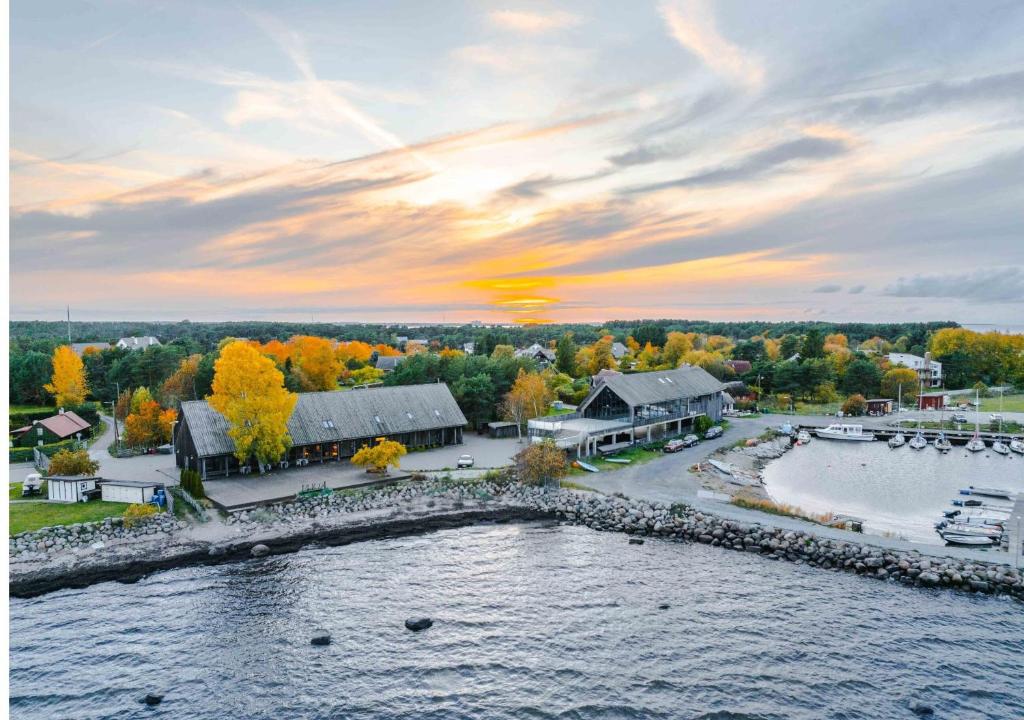 an aerial view of a house with a lake at Neeme Marina Questhouse in Neeme