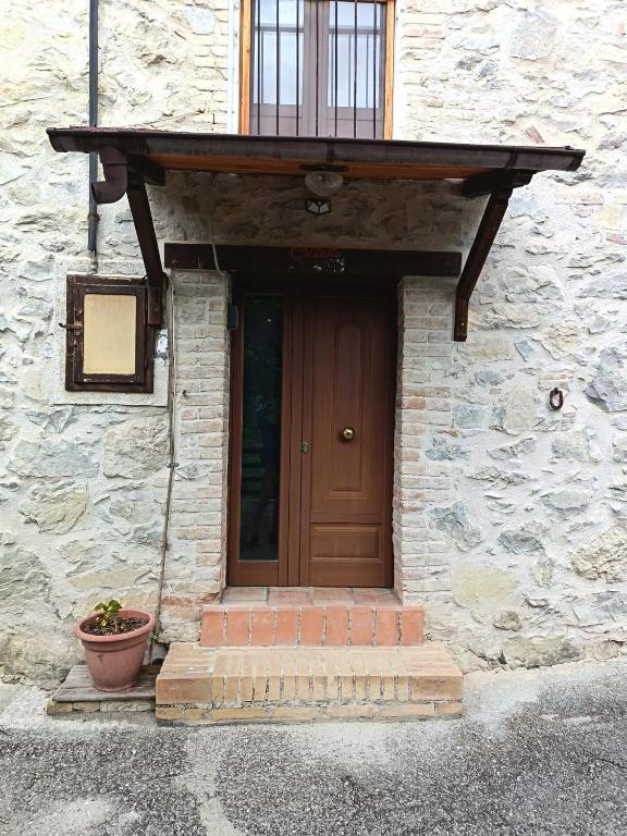 a front door of a stone building with a porch at Cristallo del Gran Sasso in Forca di Valle