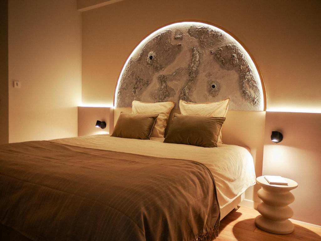 a bedroom with a large bed with a globe on the wall at Galaxy Mood - 10 min Disney in Couilly-Pont-aux-Dames