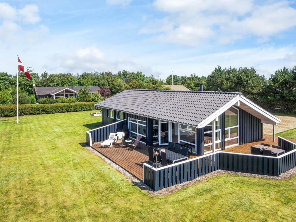 a modular home with a deck and a house at 4 star holiday home in Tarm in Tarm