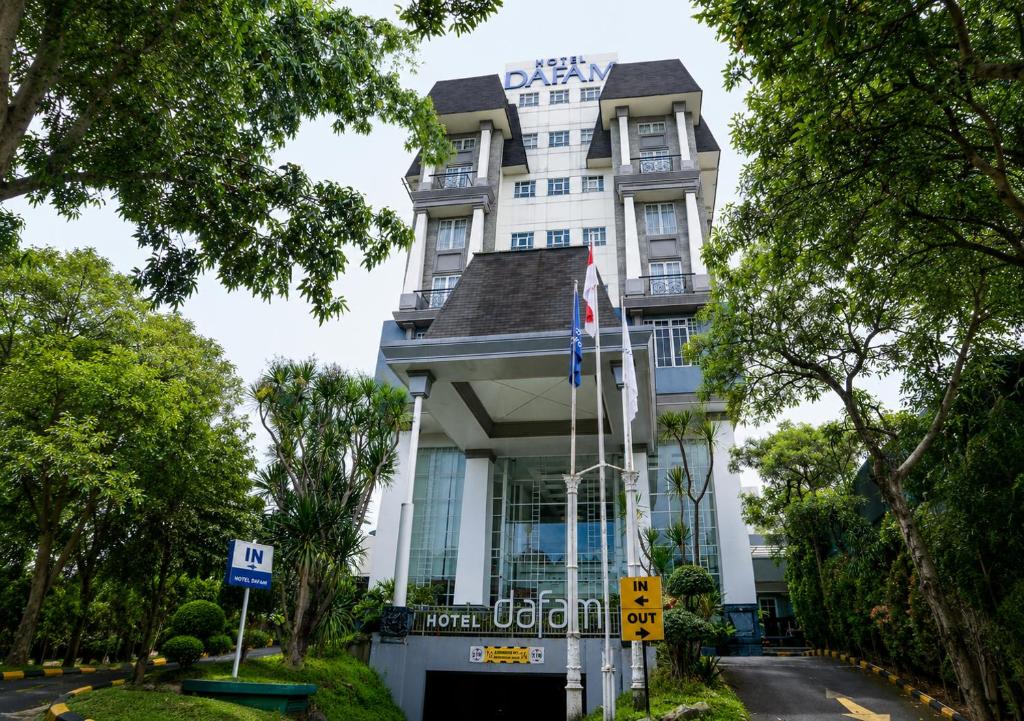 a tall white building with a sign that reads defy hotel at Hotel Dafam Semarang in Semarang
