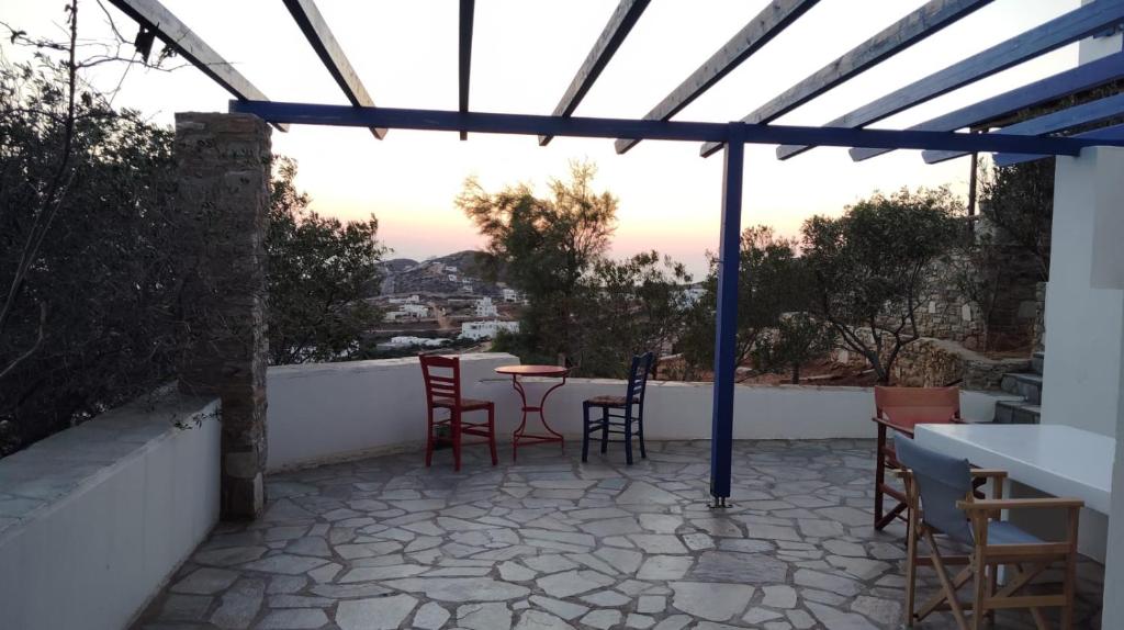 a patio with chairs and a table on a balcony at Villa Argos in Agios Georgios