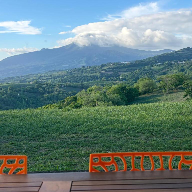 an orange bench with a view of a mountain at Villa Floru in Le Carbet
