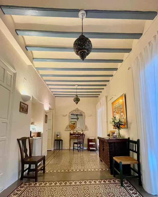 a living room with a blue and white striped ceiling at Número 9 in Medina Sidonia