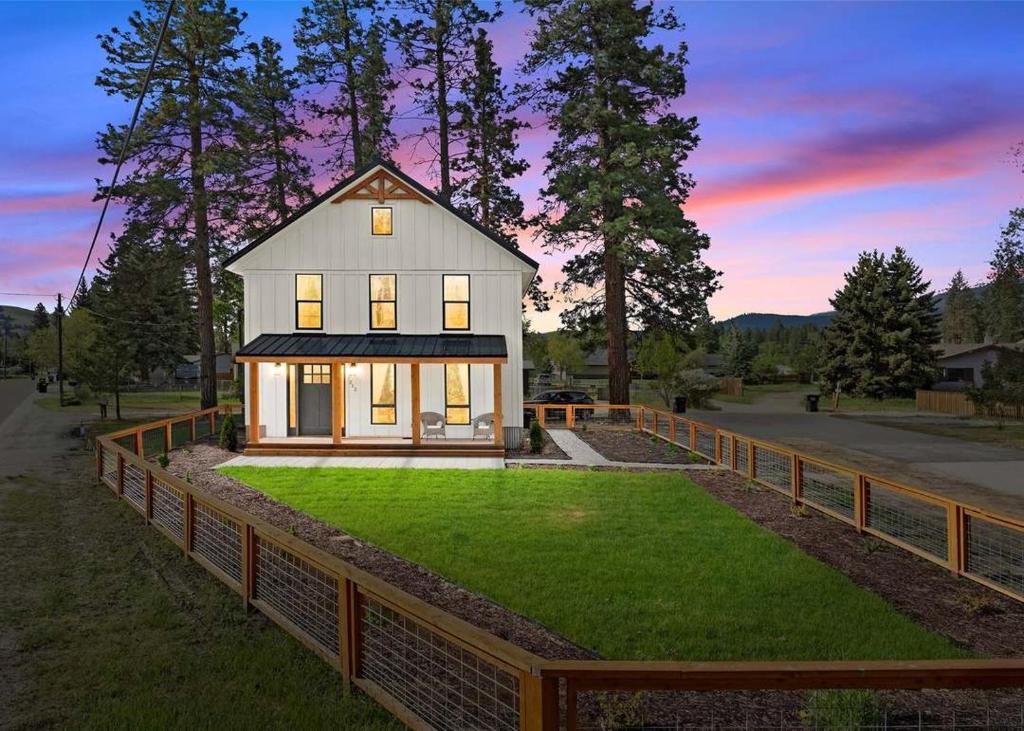 a house on a lawn with a fence at The Farmhouse in Darby