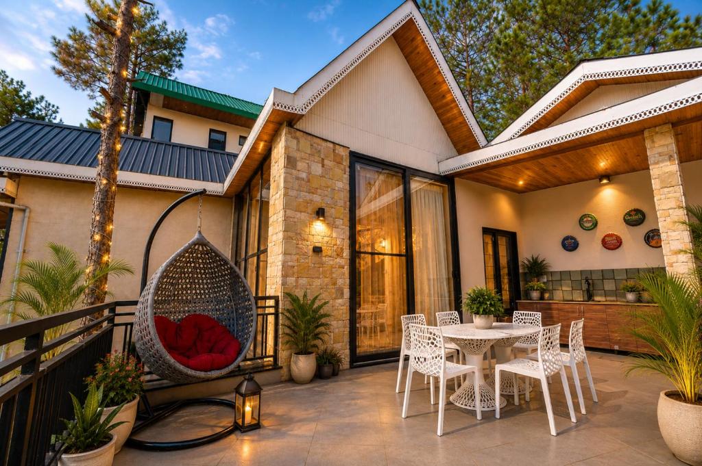a porch with a hammock on a house at Minara Meadows Kasauli in Dharampur