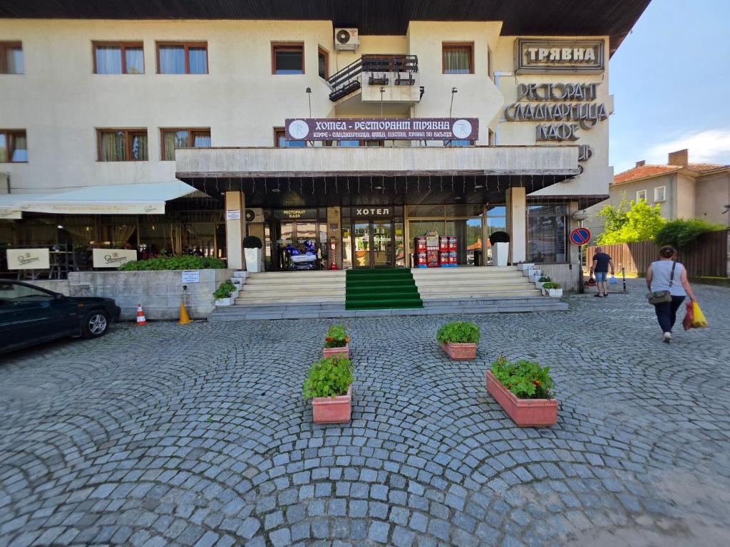 a building with potted plants in front of it at Комплекс ,,Трявна" in Tryavna