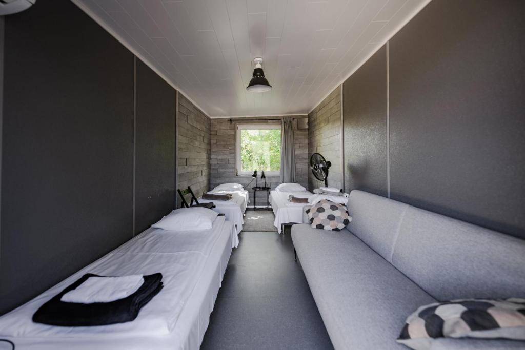 a room with two beds and a window at RUMMU Quarry Houses in Rummu