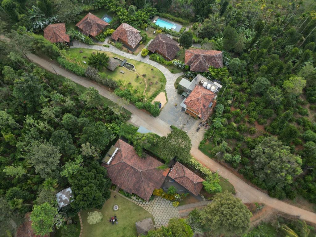 an overhead view of a group of houses with trees at Aalterra Resort by The Almanac in Wayanad