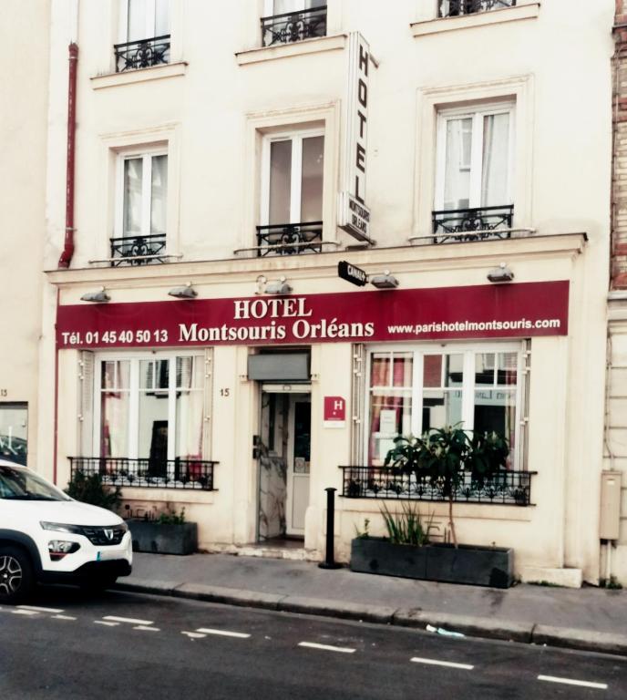 a hotel on a street with a car parked in front at Hôtel Montsouris Orléans in Paris