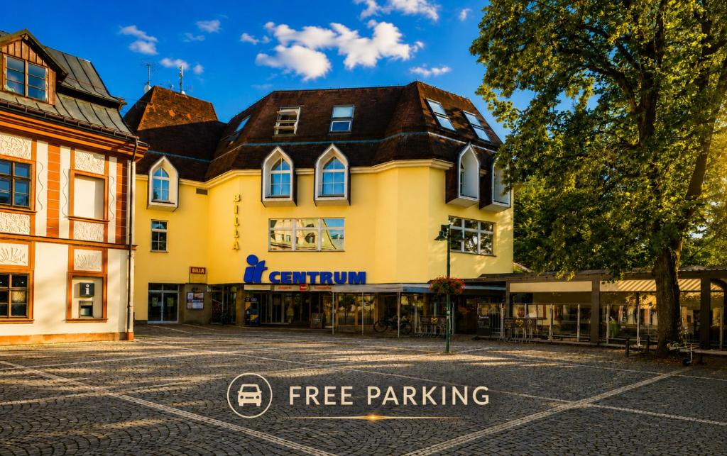 a building with a free parking sign in front of it at IT Centrum Apartments in Vrchlabí