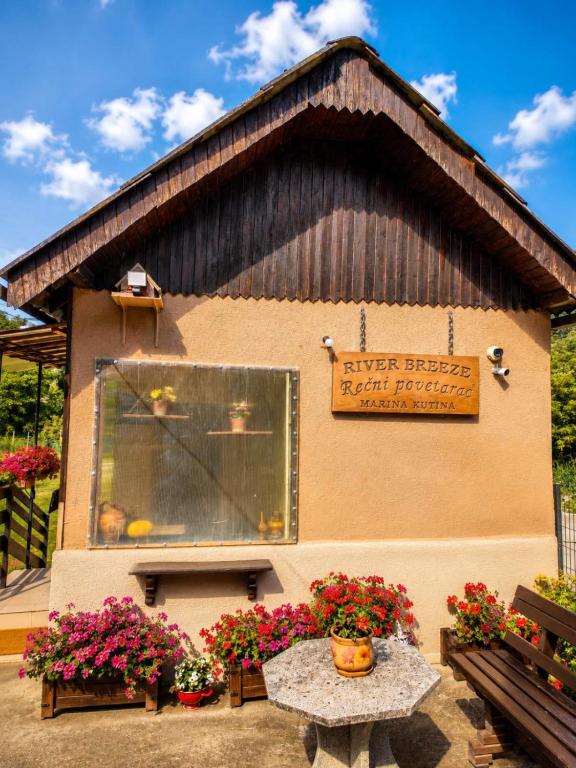 a building with a sign on the side of it with flowers at Rečni Povetarac in Niš