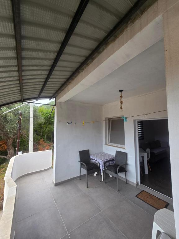 a patio with a table and chairs on it at Ignjic Apartmani in Buljarica
