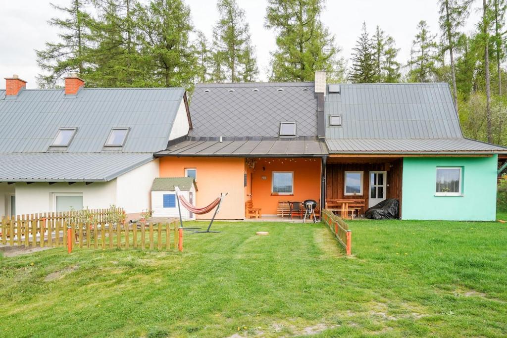 a house with a hammock in front of it at Chata Roudenka in Roudno