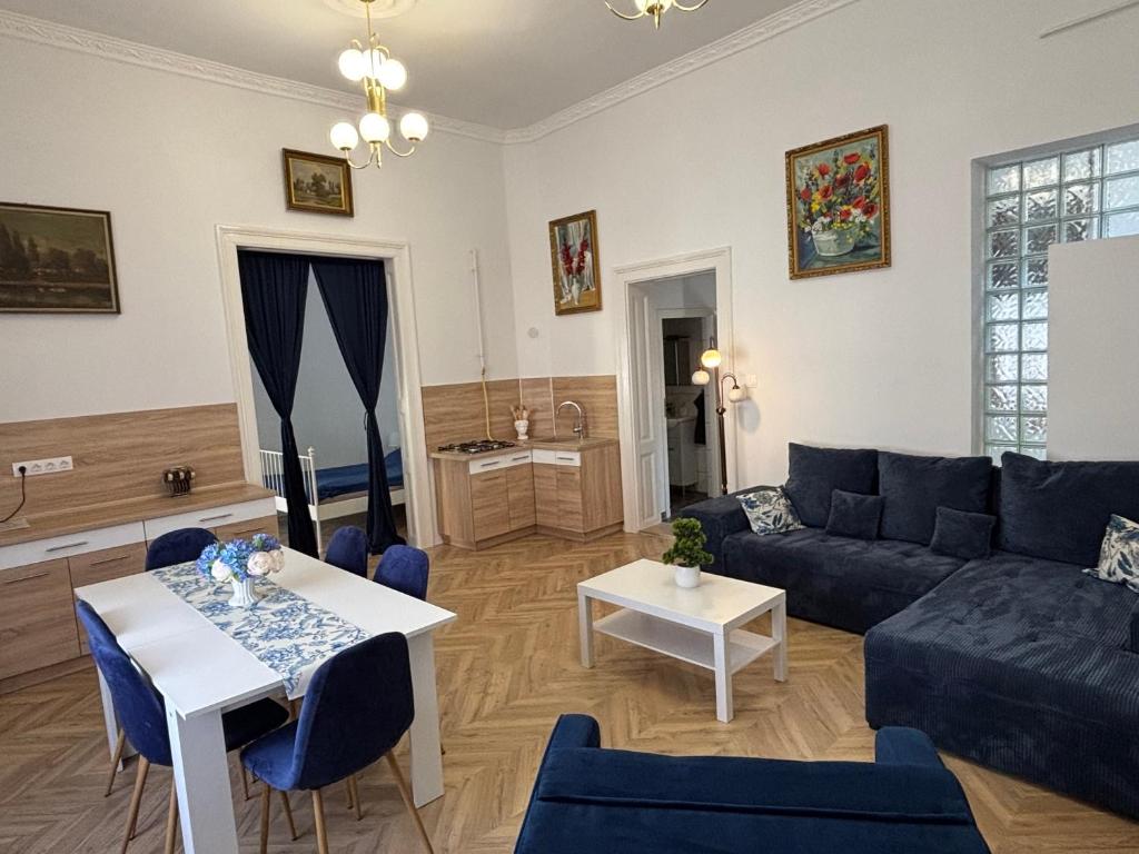 a living room with a couch and a table at Katerina Apartman in Gyula