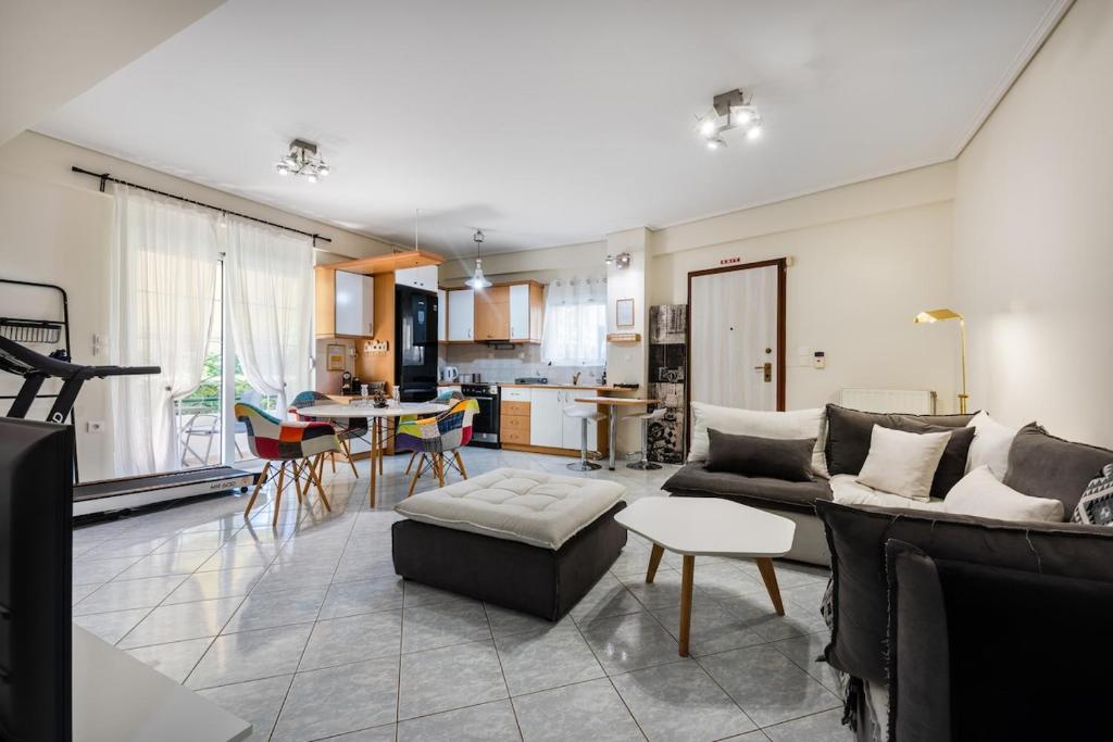 a living room with a couch and a table at Pallantides Residence in Pallini