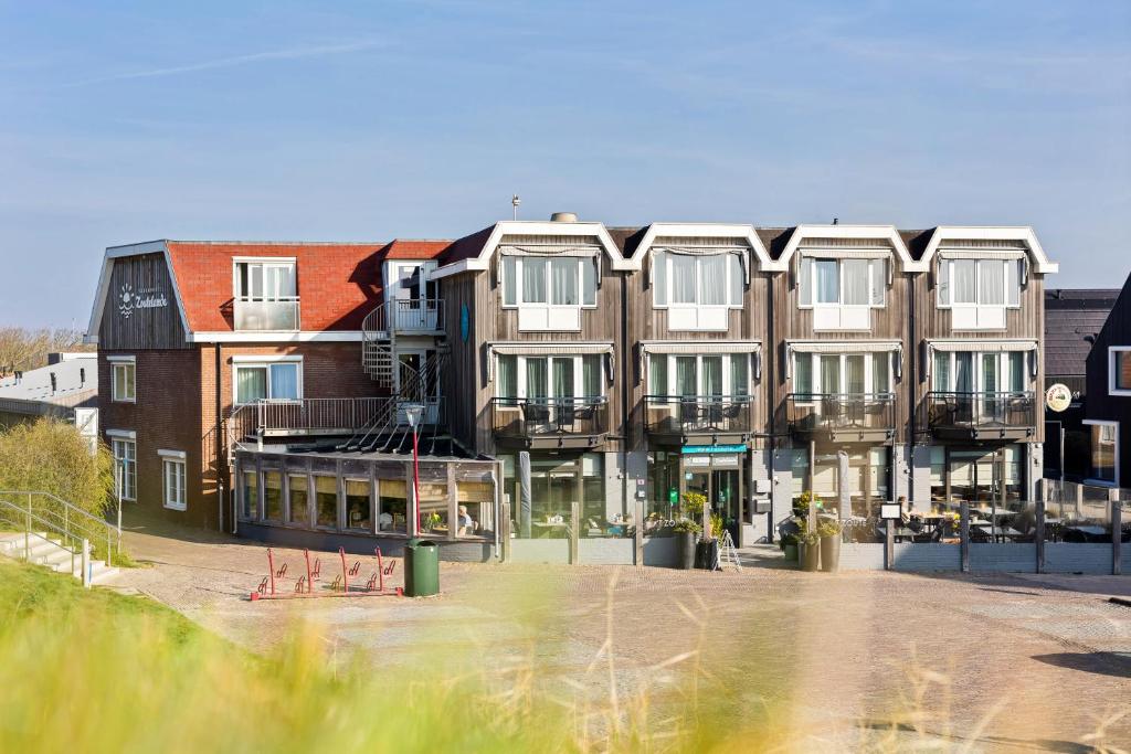 a large building with a lot of windows at Strandhotel Zoutelande in Zoutelande