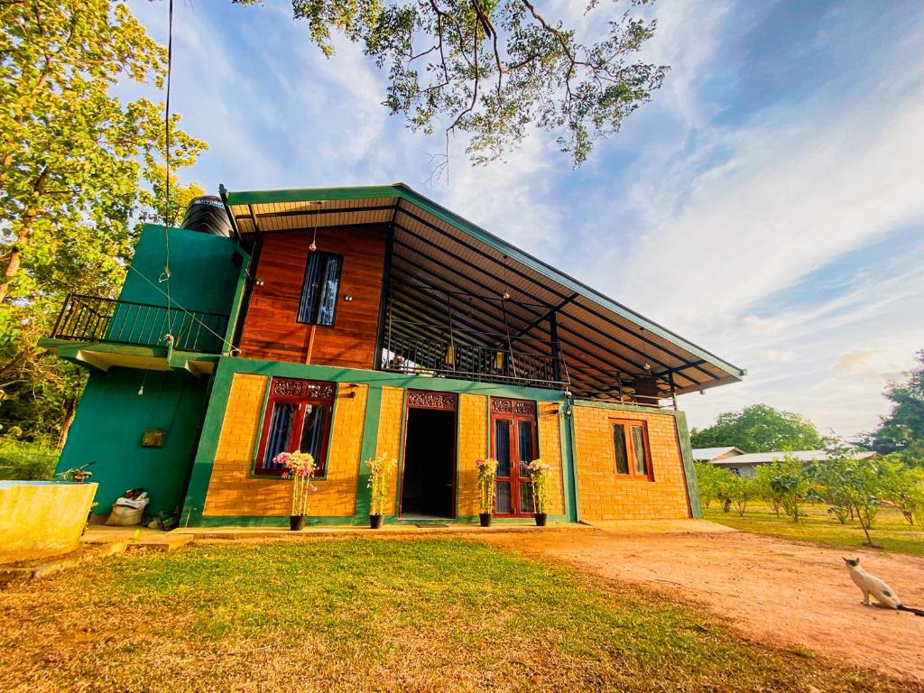 a small house with a green and yellow at Senaro Villa in Sigiriya