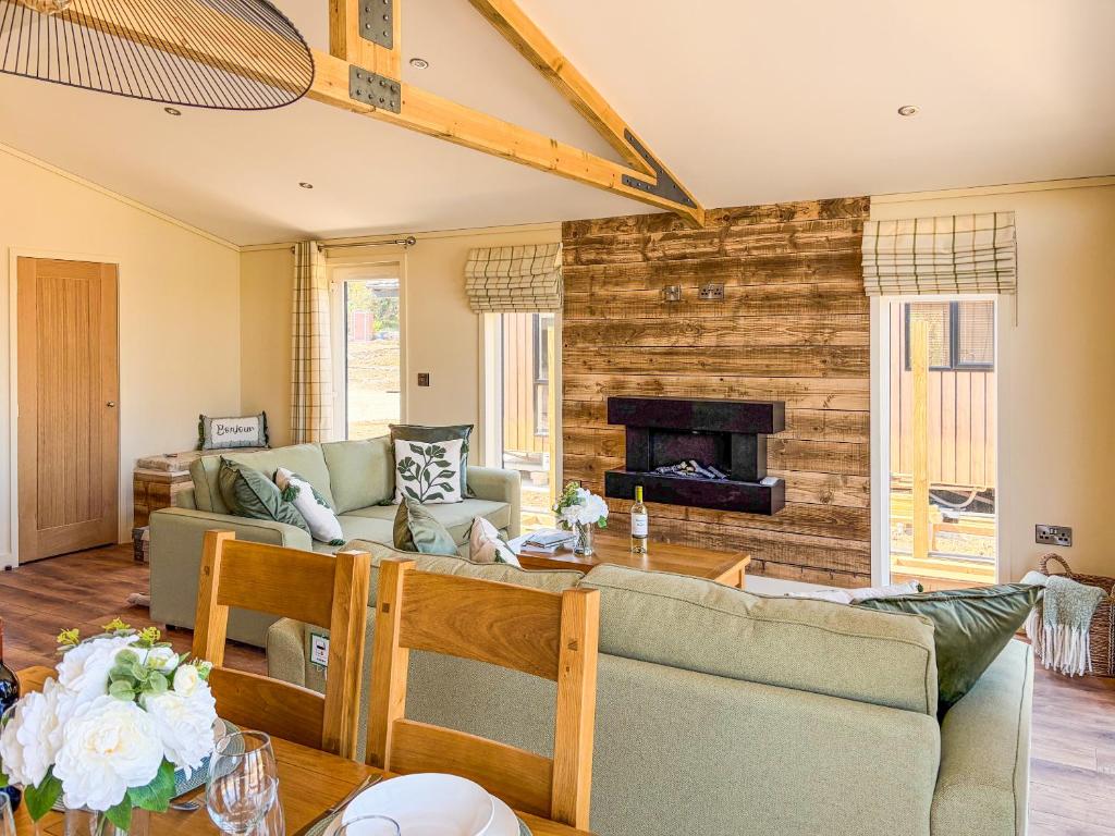 a living room with a couch and a fireplace at Lodge 3 - Uk51092 in Perranporth