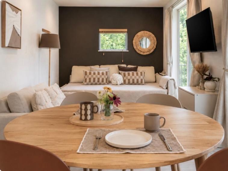 a living room with a table and a couch at Lalafofofo in Biei