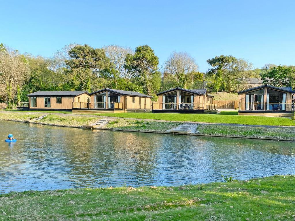 a row of houses on the side of a river at Lodge 4 - Uk51095 in Perranporth